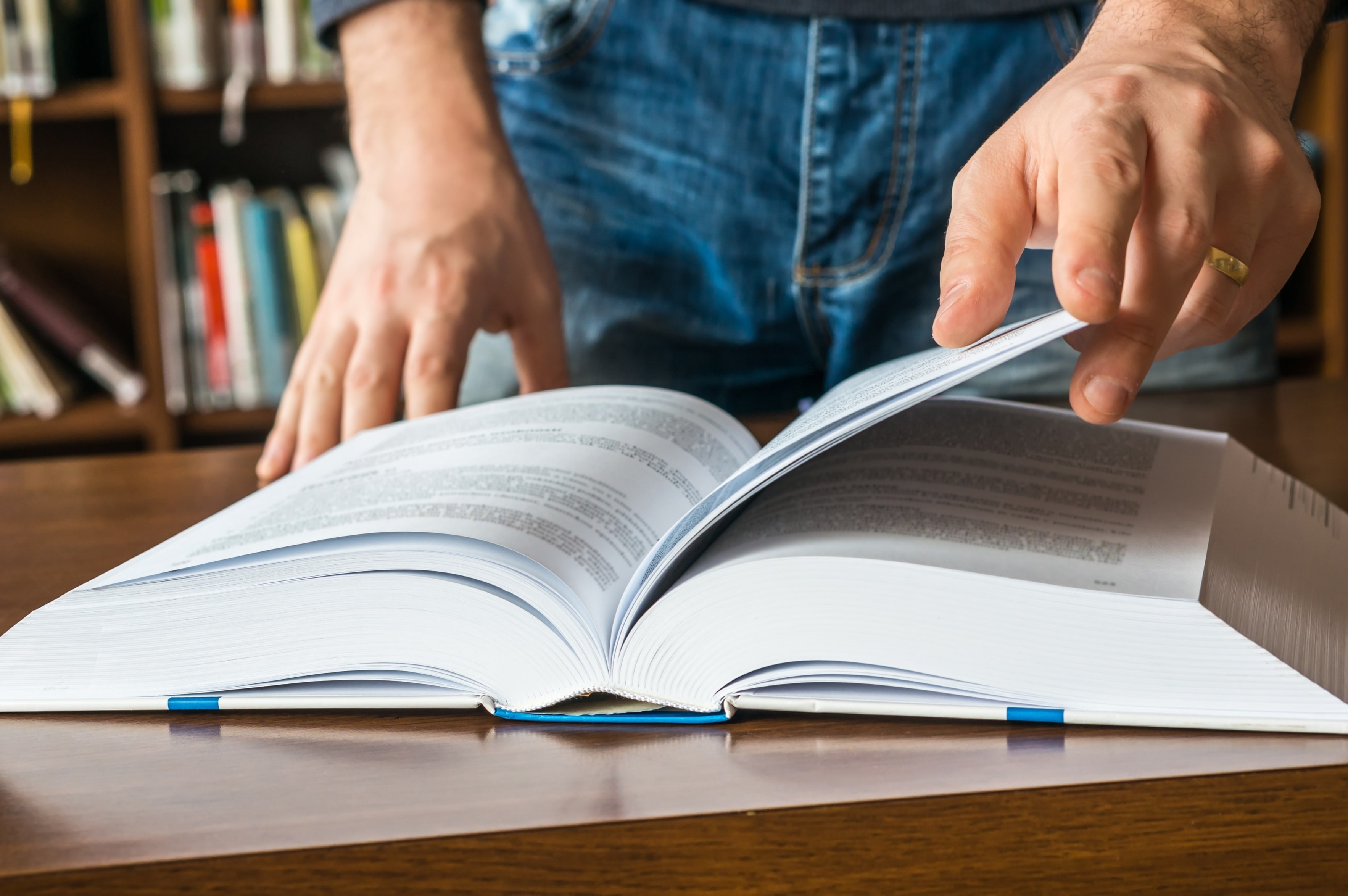 Close up of a person's hands flipping through a book