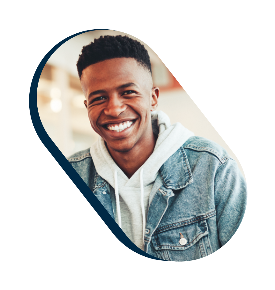 Smiling young man in a denim jacket and hoodie
