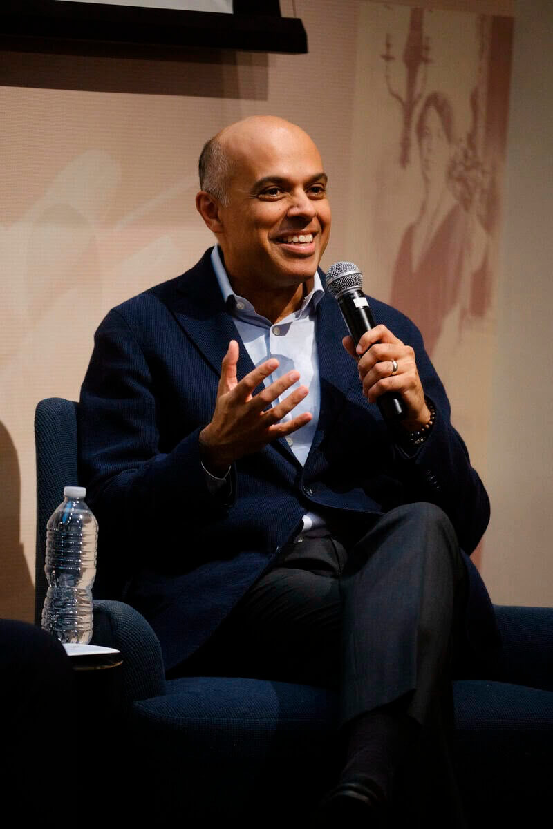Amit Sevak seated in a chair during a speaking engagement.