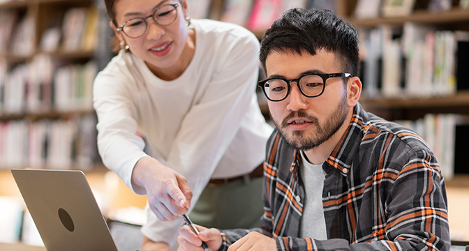 A girl instructing a boy