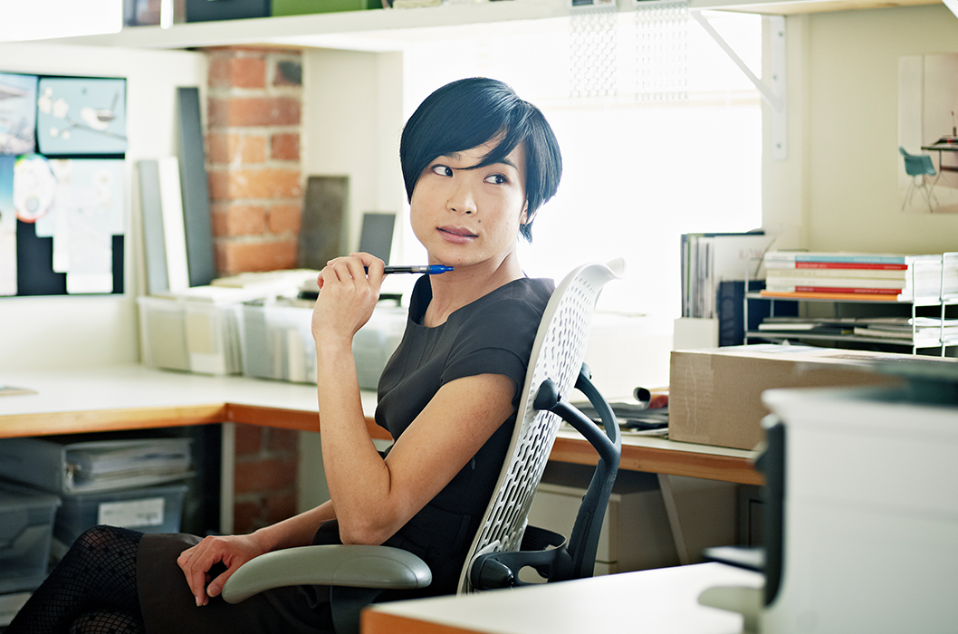 Woman sitting at a desk looking over her shoulder