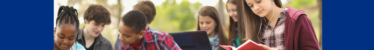 Students sitting outside reading books