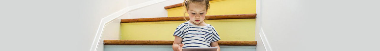 Young girl sitting on steps reading