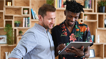 Two men looking at tablet