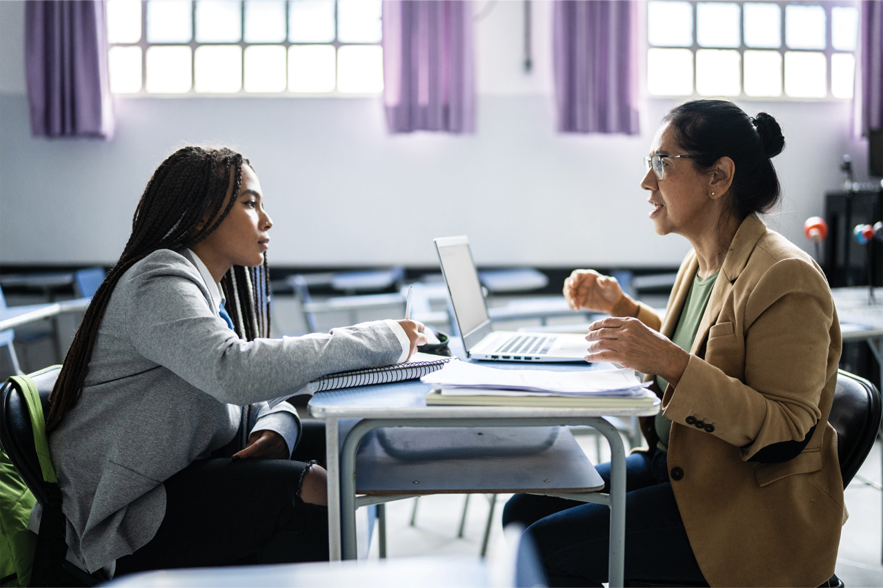 Two women's sitting Infront to each other and discussing