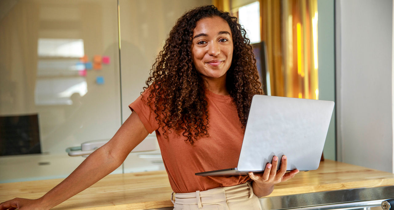A girl holding a laptop